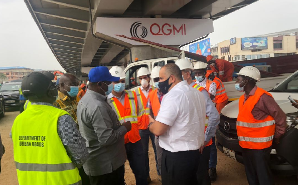 Mr. Kwesi Amoako-Atta (3rd left), the Minister of Roads and Highways, interacting with contractors working on the Obetsebi Lamptey Interchange project