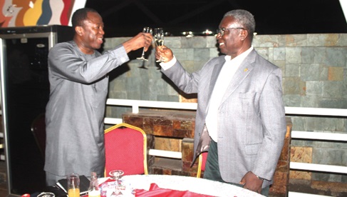 Prof. Kwabena Frimpong-Boateng (right), Physician and Cardiothoracic Surgeon, and Dr Opoku Ware Ampomah (left), Chief Executive Officer, KBTH, in a toast to celebrate his achievement. Picture: ESTHER ADJORKOR ADJEI