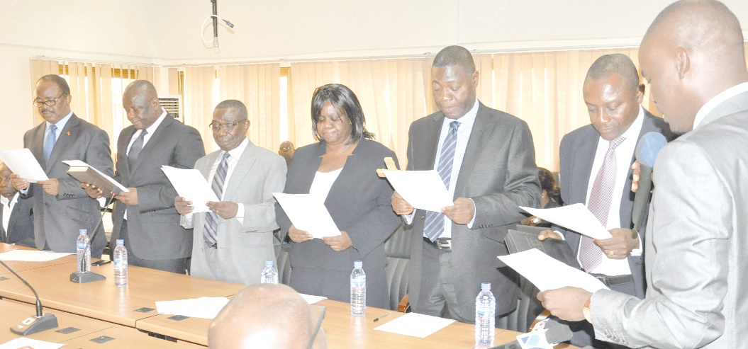  Mr Haruna Iddrisu (right) administering the oath of office to members of the new board of ADB