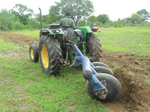 A tractor ploughing the land
