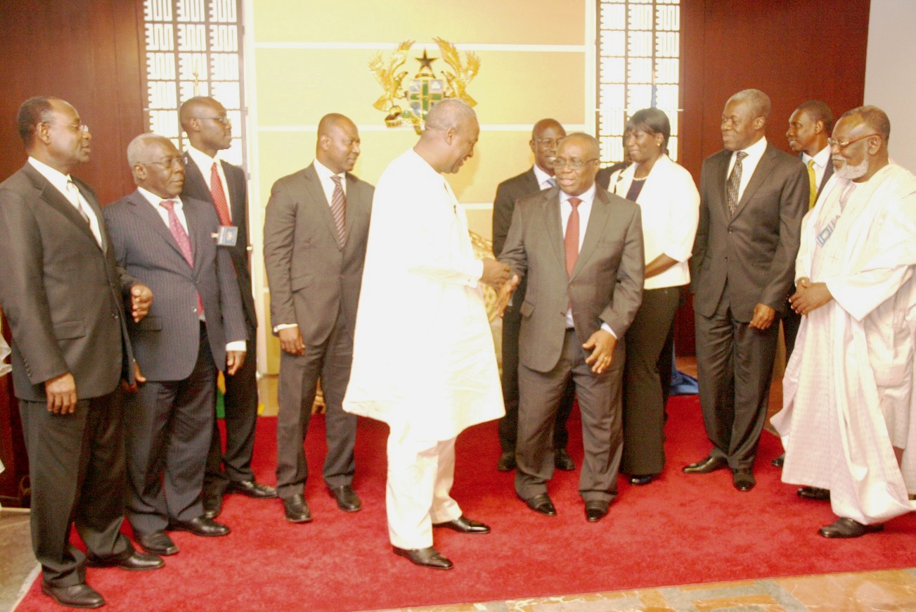 President Mahama interacting with the Governor of the Bank of Ghana after swearing in board Members of the Bank of Ghana