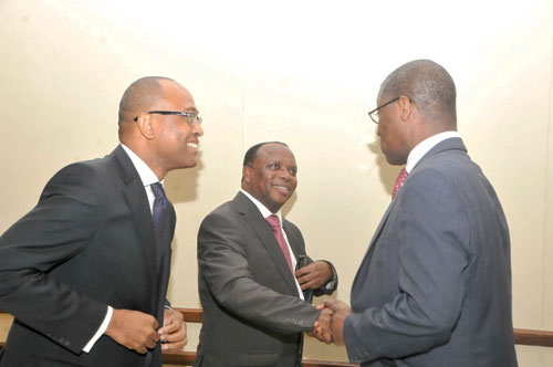 The Deputy Governor, Mr Millison Narh interacts with banking chiefs, Mr Asare Akuffo (R) and Simon Dornoo (L)