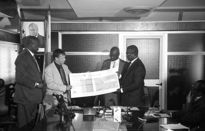Mr Thorvaldsen Reidar (2nd left) being supported by Dr Dawson-Ahmoah (left) to present the cheque to the two deputy ministers of Finance, Mr R.K. Hagan (right) and Mr C. Ato Forson.