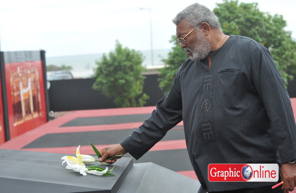 Former President J.J. Rawlings has a flower for his former lieutenant who served as his vice president. 