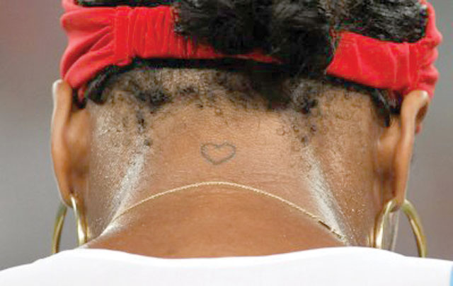 Serena Williams displays her 'love' sign tattoo at the back of the neck
