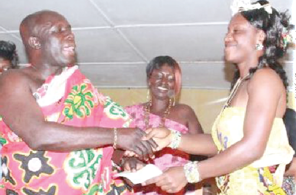 Lordina (right) receiving her cheque after being crowned Miss Kundum 2013