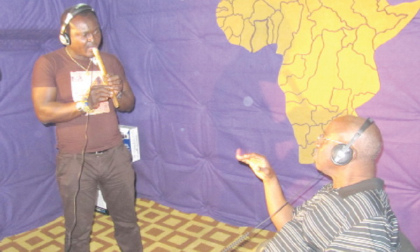 Kwaw Ansah (seated)  works on the score  with flutist Dela Botri