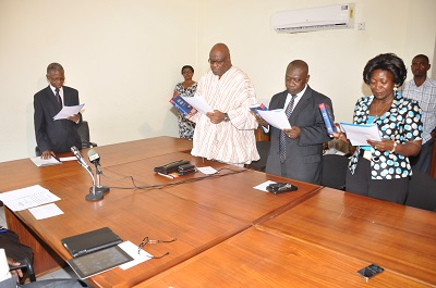 Justice Joseph Akamba (extreme left), a Supreme Court Judge, swearing in new members of the National Media Commission (NMC) at a ceremony in Accra. From right are Mrs Della Sowah, Mr O.B. Amoah and Mr Fritz Baffuor.  Picture: SAMUEL TEI ADANO