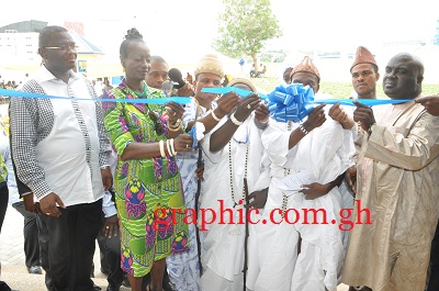Ms Sherry Ayittey (2nd left), Minister of Health, being assisted by Mr Julius Debrah (extreme right), Greater Accra Regional Minister, and some chiefs from the La Traditional Council to cut the tape to inaugurate the  Greater Accra Regional office of the National Health Insurance Scheme. Picture: GABRIEL AHIABOR