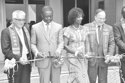 Ms Sherry Ayittey (2nd right) being assisted by Dr Stephen Opuni (2nd left), Mr Gene Cretz (left), the US Ambassador to Ghana and Dr Jeffrey Sturchio (right), Trustee, United States Pharmacopeial of Ghana, to cut the tape to inaugurate the facility. INSET: The front view of the Centre for Pharmaceutical Advancement and Training. Picture: SAMUEL TEI ADANO