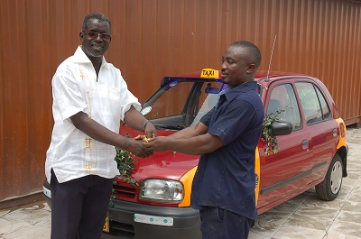 The Chief Executive of Chocho Industries, Alhaji Mustapha Boateng, (left) handing over the keys to the taxi- cab to Mr Sheriff Â Tetteh (right). Picture: Seth Takyi Boateng