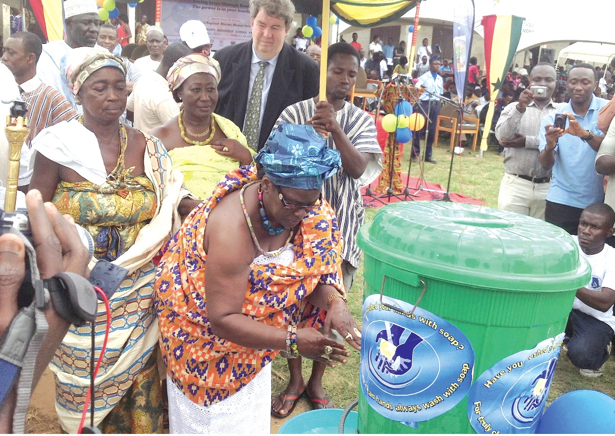The Okyenhemaa, Nana Adutwumwaa Dokua, taking her turn to wash her hands with soap during the Global Handwashing Day.
