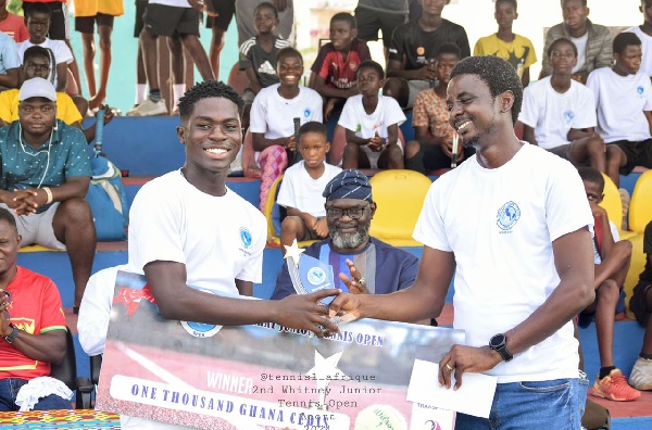 Samuel Ayittey (left) receiving his trophy and cash prize from Mr Orimoloye Abiodun, organiser of the competition