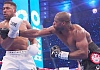 Daniel Dubois (right) unleashes a powerful right to Anthony Joshuaâs body