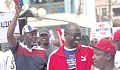 Dr Mathew Opoku Prempeh (hand raised), running mate to the NPP flag bearer, responding to cheers from supporters during the health walk. With him are Nana Agyei Baffour Awuah (2nd from left), NPP parliamentary candidate for Manhyia South, and a party supporter