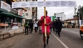 Texas Kadri Moro, the executive director of Arise for Justice International, protests with placards nailed on a cross on the street of Accra, Ghana, Sept. 12, 2024.