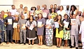 The participants showing off the guide documents for the implementation of the WASH Investment Plan for the various local assemblies