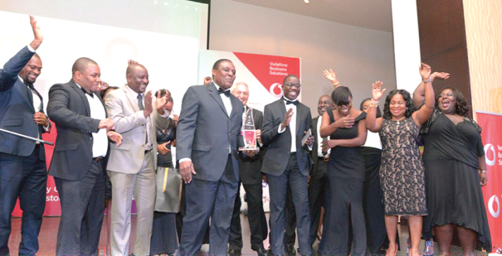 Mr Jim Baiden (with plaque), Deputy Managing Director of Fidelity Bank, together with his colleagues, displays the Bank of the Year Award.