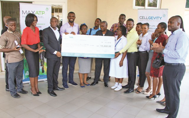  Dr Kofi Nyarkopong (3rd left) and staff of Max International presenting the cheque to Mr Kambarin Kombien