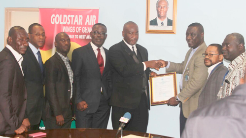 Mr Eric Bannerman (5th left) receiving the certificate from Mr Martey Boye Atokloh while directors from the GCAA and Goldstar look on