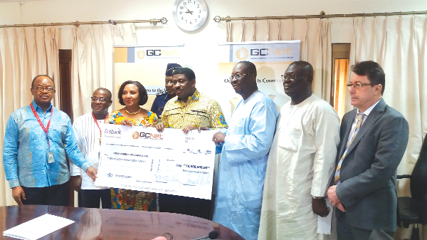 Dr Omaboe (3rd right) presenting a dummy cheque to Mrs Quartey