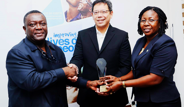 Ambassador Sylvanus Tamaklo handing over the Award and Certificate to Mr Arcos and Mrs Larbi.