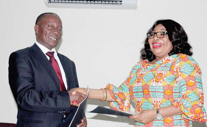 Ms Lydia Lariba Bawa (right), Commissioner, NIC, Ghana and Mr Sammy Makove (left), Commissioner, Insurance Regulatory Authority, Kenya, exchanging the MoU