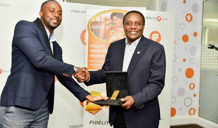 Ultimate winner Festus Armoh Nweamah (left) receiving a 1kg 24 carat gold bar from Mr Jim Baiden