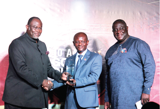 Mr Ekwow Spio -Gabrah (left),  the Minister of Trade & Industry, receiving an honorary award  from Dr Kwame Akuffo Anoff-Ntow (middle). Right is Mr Joel Nettey.