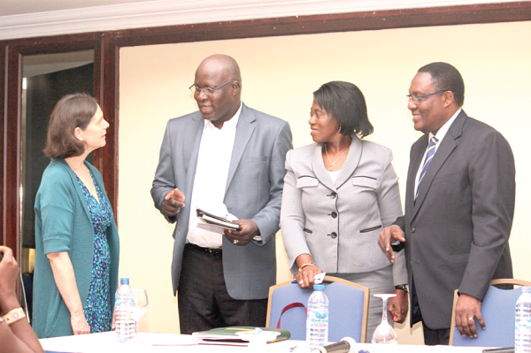 Mr Diawary Nouare (2nd left), Regional Director, Care International interacting with Ms Pamela Eser (left), Advisor, UNCDP as Mrs Magdalene Apenteng (3rd left), Director, Financial Sector Division, MOFA and Mr Jim Baiden (right), Managing Director, Fidelity Bank look on in admiration