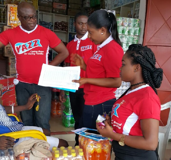 Chief Finance Officer of Lexta, Mr. Bismark Adom-Dankwah [extreme left] with other staff interacting with a customer