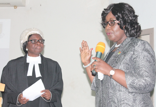 Rev. Mrs Patricia Sappor (right), being sworn in as the President of the Chartered Institute of Bankers (CIB) Ghana, by Mrs Justice Georgina Mensah-Datsa (left), High Court judge