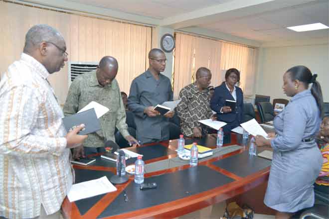 Mrs Grace Oppong-Dolphy (right) taking the Audit Committee through the official oaths. The members include Mr Boakye Agyarko (left) and Mr Augustine Addo (2nd left)