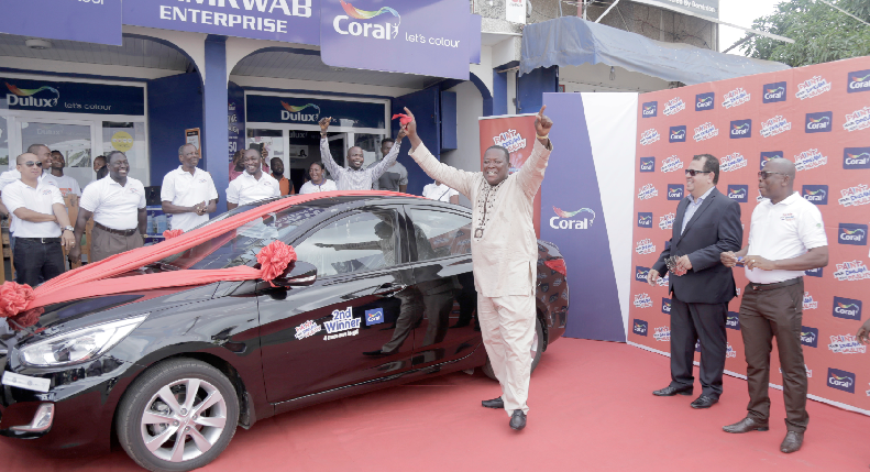 Mr Mensah Koevi (3rd right) celebrating by his new car. Also in the picture include Mr Yaw Bonnah-Sarpong (right), the General Manager of M&K Ghana Ltd. and Mr Luiz Carlos Da Silva (2nd right), the Business Development Manager of Coral.