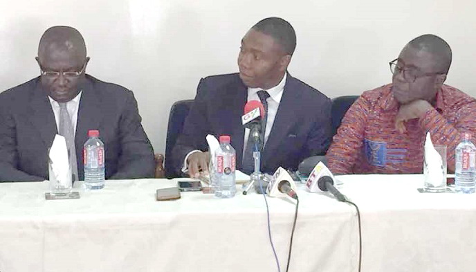 Mr David Klutse (middle), MD of Intravenous Infusion Limited, addressing brokers at the Ghana Stock Exchange. 