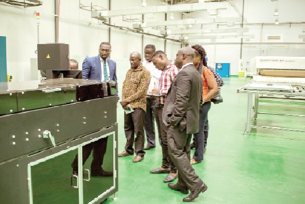 • Mr Boateng (left) explaining how the solar machines work to the Daily Graphic team