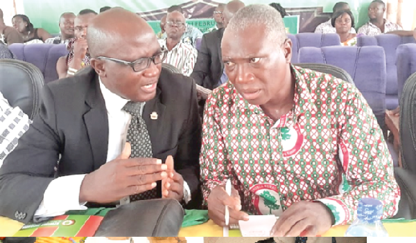 Mr John Swanzy (right), conferring with Lawyer Owusu Sekyere, the Vice-President of the Association of Rural Banks,  Ashanti Chapter during the meeting