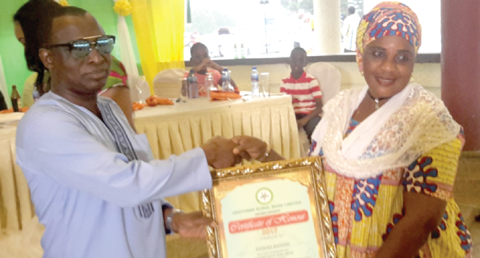 The CEO, Mr Siaka Baba Ahmed, presenting a certificate of appreciation to   a customer 