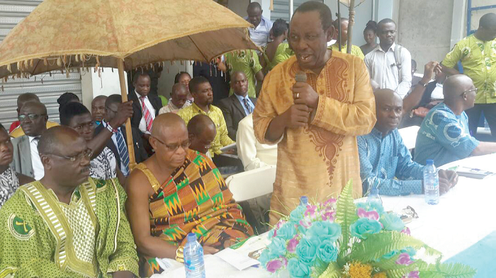 Dr Nana Akowuah Boamah, Board Chairman of Otuasekan Rural Bank, addressing the gathering. Looking on are a board member and Nana Yaw Daani, Otumfuo Asuamehene.