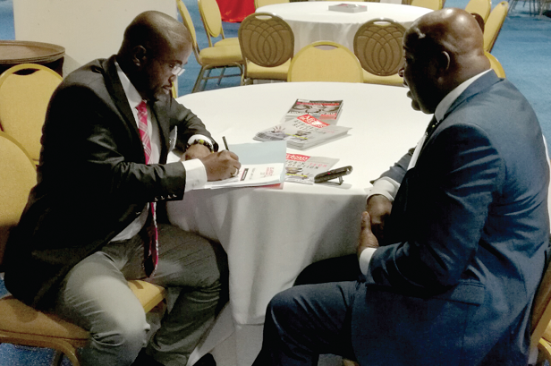 Mr Michael Okyere Baafi (right) talking to Mr Charles Benoni Okine, Assistant Editor, Graphic Business