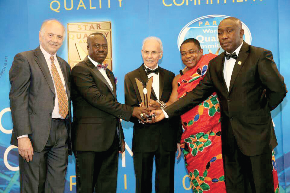 Noble Agyei-Poku CEO (right), Nana Dr Appiagyei Dankawoso I (in cloth) and Lawyer Asante Krobea, Chairman of the bank (2nd left) receiving the award in France from a representative  of BLD