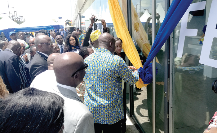 Executives of the bank and special dignitaries cutting the tape for the opening of the new head office