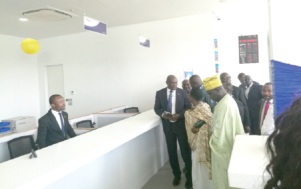 Mr Gbenga Odeyemi (arrowed), Managing Director of FBN Bank, interacting with some dignitaries after the opening of the bank’s head office