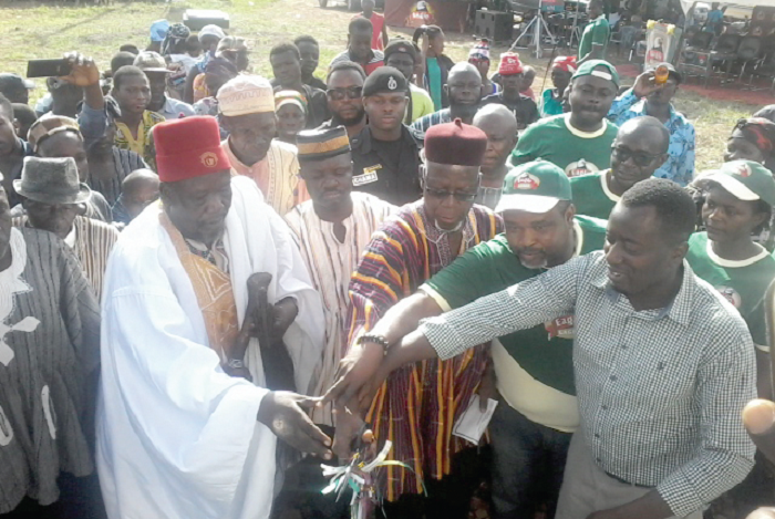  Mr Rockson Ayine Bukari (middle), Upper East Regional Minister, and Mr John Baptist Akado (right), Brands Manager, Eagle Larger, cutting the tape to inaugrate the project