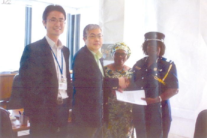 ACP Twumasi receiving her certificate  of participation from the Resident Representative of JICA, Mr Hoshi Hirofumi