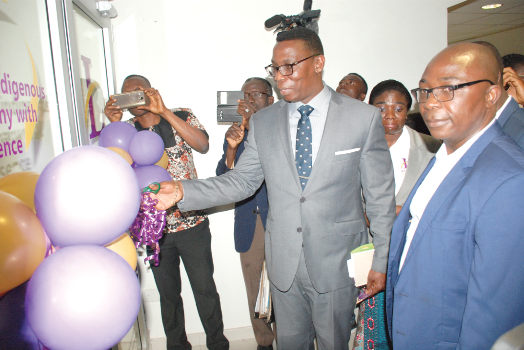 Mr Ofori cutting the tape to inaugurate the Loyalty Insurance Company Limited 