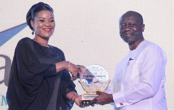 Mrs Abigail Mckorley(L) receiving the Ghana Club 100, 36th prize from Finance Minister, Ken Ofori Atta