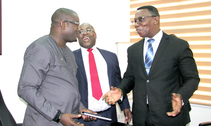 Mr Justice Yaw Ofori (right) explaining a point to Mr Charles Kofi Adu Boahen (left). With them is Mr Emmanuel  Ankrah (middle), Board Chairman, National Insurance Commission. Picture: ESTHER ADJEI