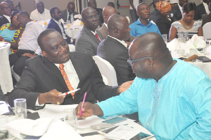 Mr Kenneth Ashigbey (right),  Managing Director, Graphic Communications Group Limited  in a conversation with Mr Peter Osei Duah, CEO of ALLSTAR Insurance Brokers