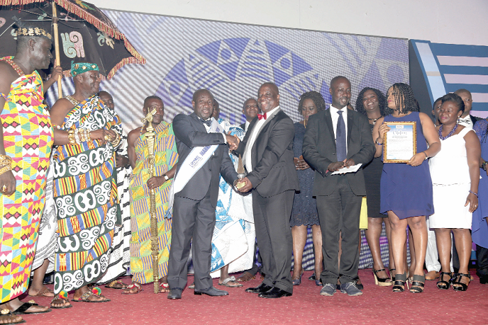 Mr Patrick Akorli, MD of GOIL presenting a plaque to Mr Ebenezer Twum Asante, CEO, MTN Ghana as the Marketing Man of the Year 2016. Also in the picture include Nana Bonsu Ayepe II (left), Kwahu Pepeasehene